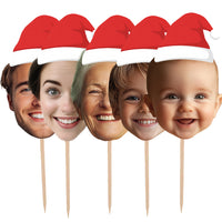 Five cake toppers with Santa hats on wooden sticks against a white background personalised christmas decorations